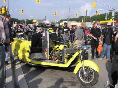 A 3 wheeled motorcycle made from a 1960 Chevy!  A man and wife drove this V8 beauty up from Florida!