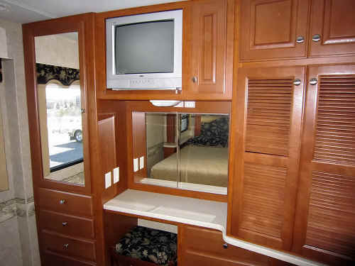 The mirror behind the bedroom computer station opens to reveal a window